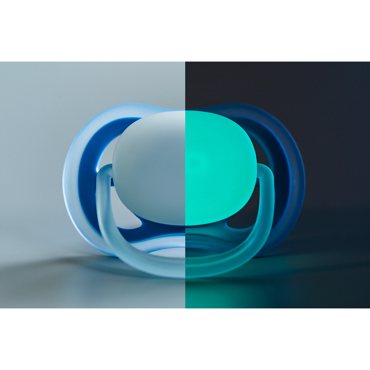 Blue and green pacifier on a gradient background