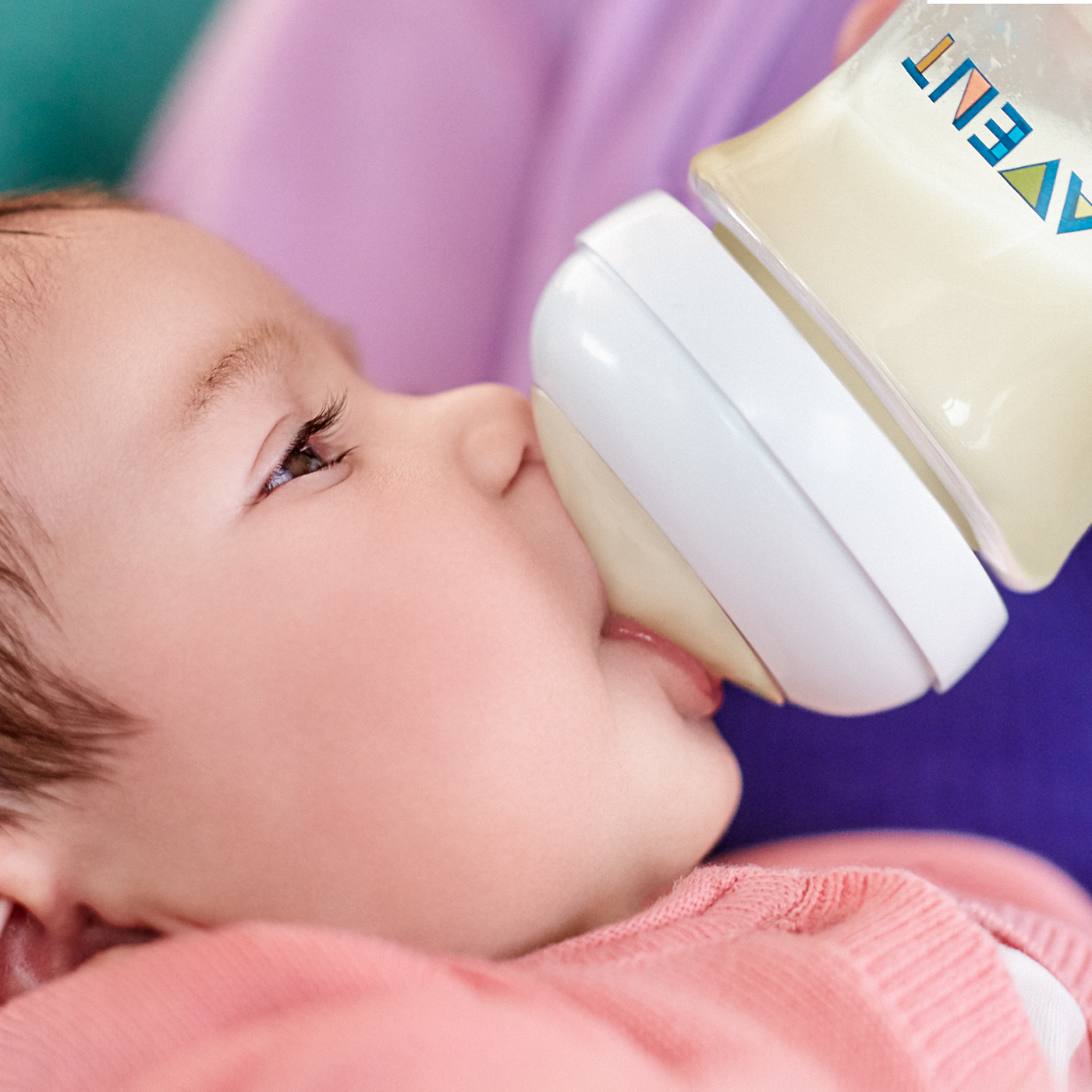 Baby drinking from a bottle with Avent logo