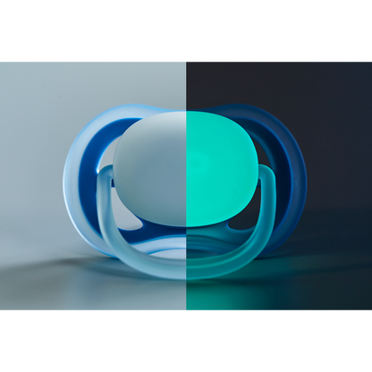 Blue and green pacifier on a gradient background