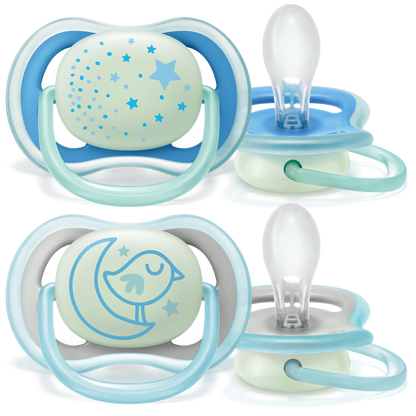 Two sets of baby pacifiers with night light feature on a white background