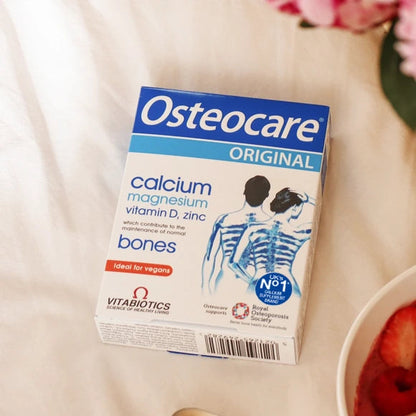 Osteocare supplement box on a table with a bowl of fruit