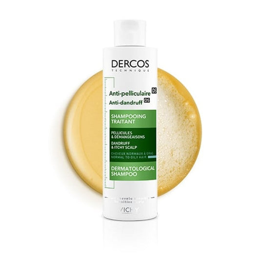 Dercos anti-dandruff shampoo bottle with a sponge on a white background