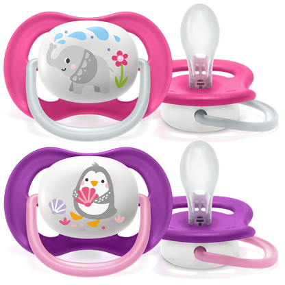 Two pairs of baby pacifiers with cartoon designs on a white background