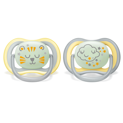 Two baby pacifiers with cartoon designs on a white background