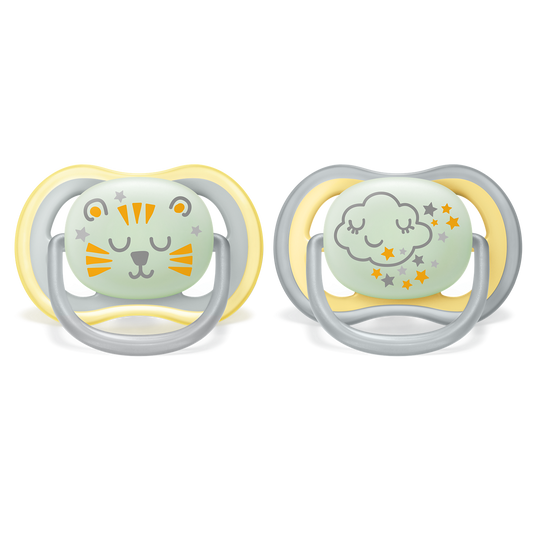 Two baby pacifiers with cartoon designs on a white background