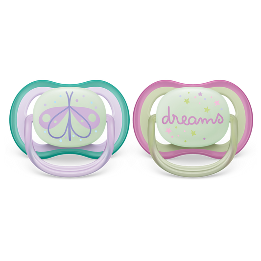 Two baby pacifiers with butterfly and 'dreams' designs on a white background